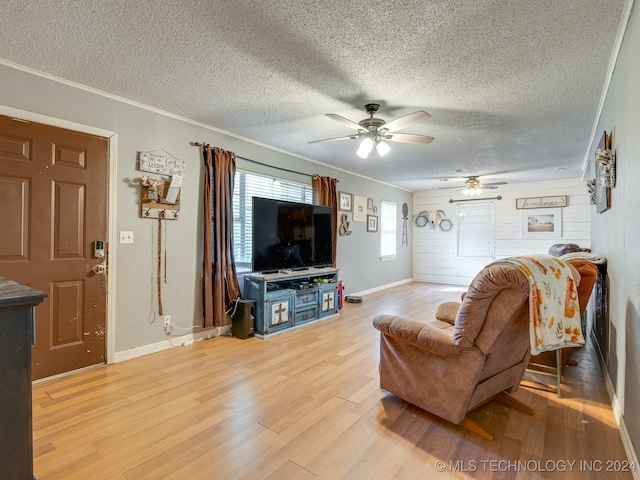 living room with ceiling fan, hardwood / wood-style flooring, crown molding, and a textured ceiling