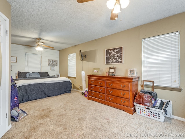 carpeted bedroom with a textured ceiling and ceiling fan