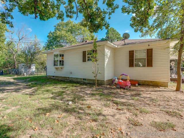 back of property featuring a yard