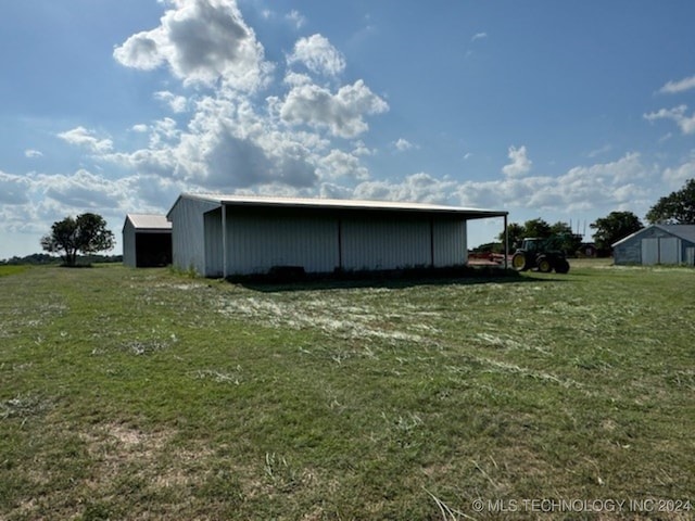 view of outbuilding featuring a yard