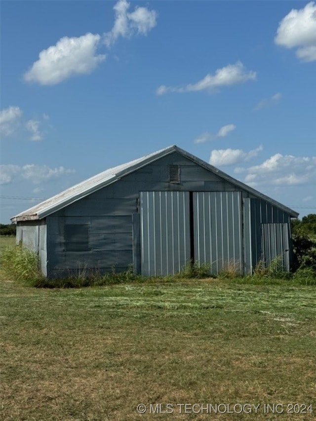 view of outbuilding with a lawn