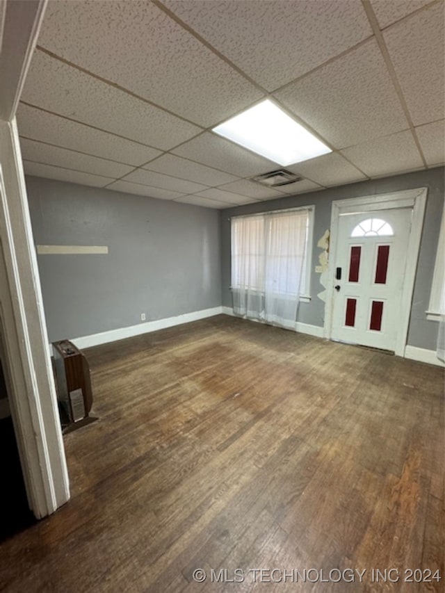 interior space with wood-type flooring and a paneled ceiling