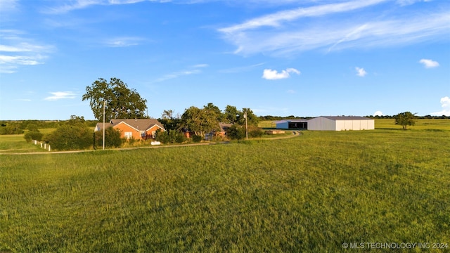 view of yard with a rural view and an outbuilding