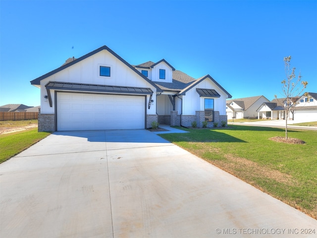 view of front of property with a front yard and a garage