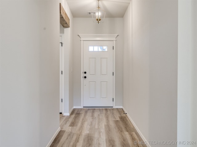 entryway featuring a chandelier and light hardwood / wood-style flooring