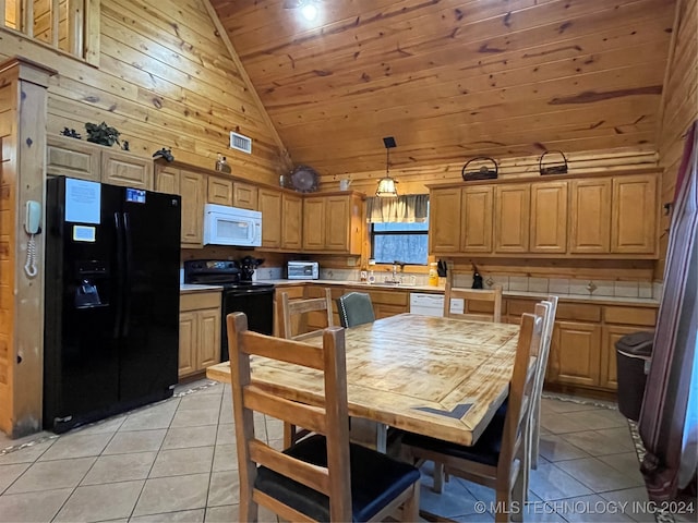 kitchen featuring decorative light fixtures, light tile patterned floors, high vaulted ceiling, and black appliances