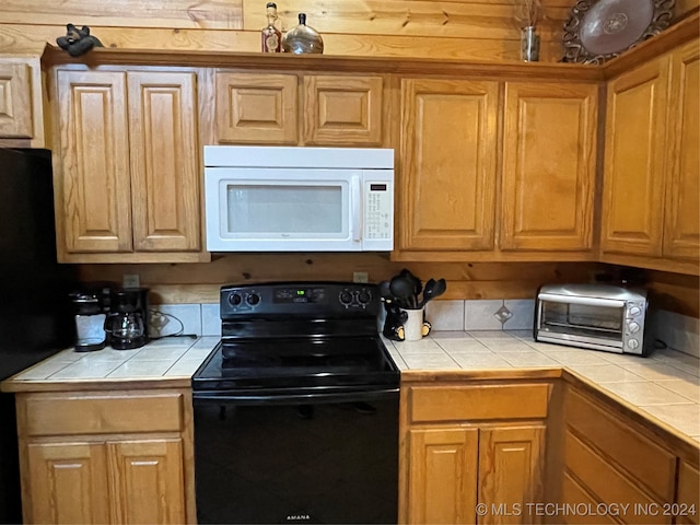 kitchen featuring tile countertops and black electric range