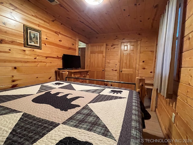 bonus room with wooden ceiling and wood walls