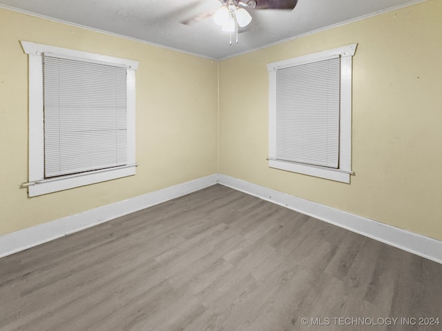 empty room with light hardwood / wood-style floors, ornamental molding, and ceiling fan