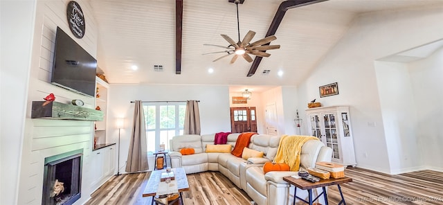 living room featuring beam ceiling, a fireplace, light hardwood / wood-style flooring, high vaulted ceiling, and ceiling fan