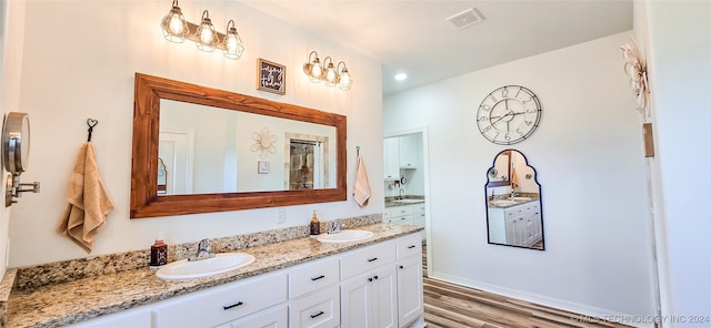 bathroom featuring vanity and hardwood / wood-style flooring