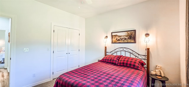 carpeted bedroom featuring ceiling fan and a closet