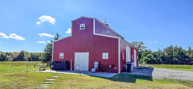 view of outdoor structure featuring a lawn and a garage