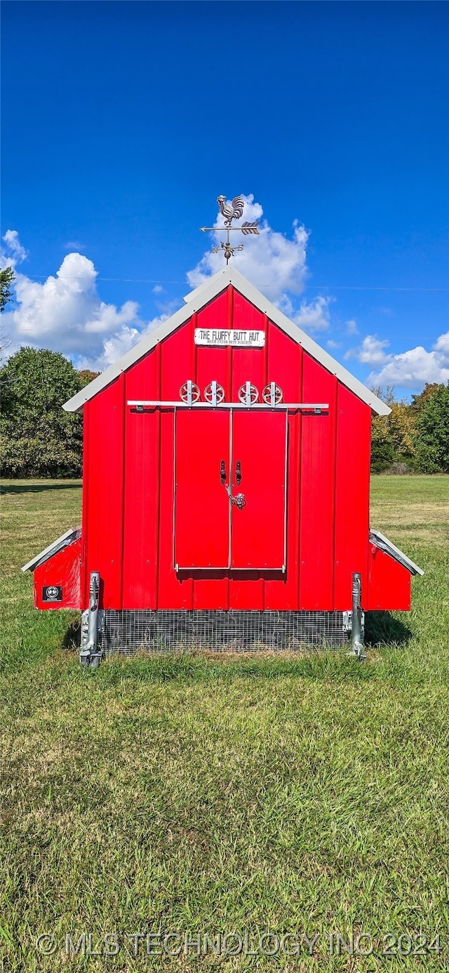 view of outbuilding featuring a lawn