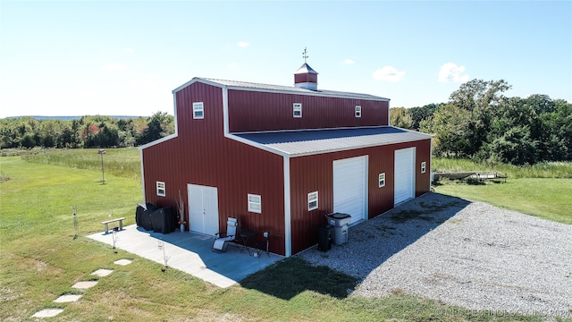 view of outdoor structure with a yard and a garage