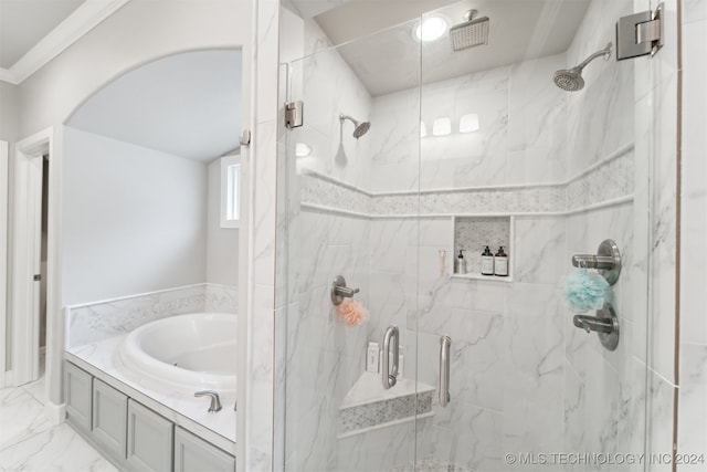 bathroom featuring ornamental molding and separate shower and tub