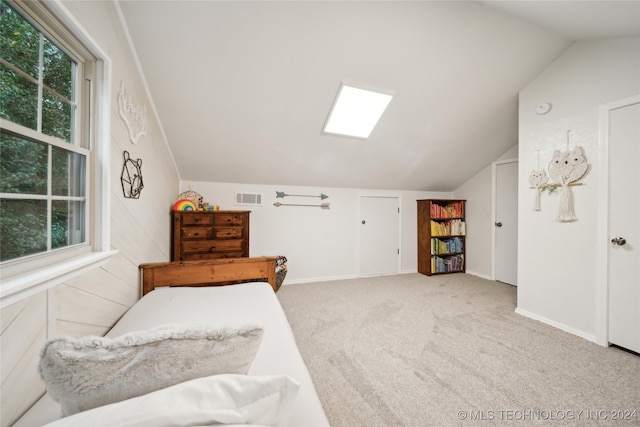 carpeted bedroom with vaulted ceiling