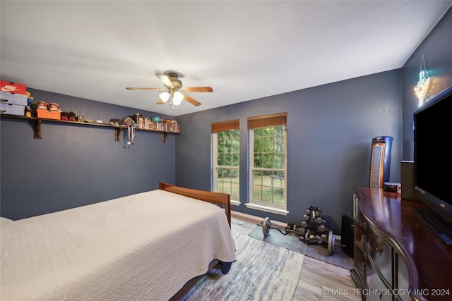 bedroom featuring ceiling fan and light hardwood / wood-style flooring