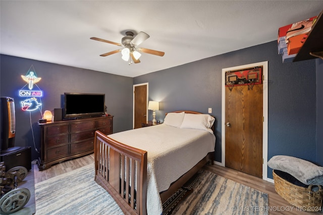 bedroom with ceiling fan and hardwood / wood-style floors