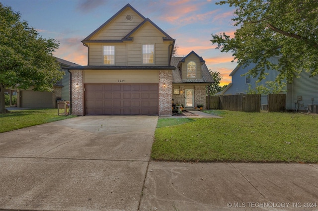 view of property featuring a yard and a garage