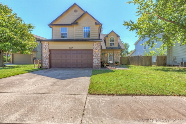 view of front property featuring a front lawn and a garage