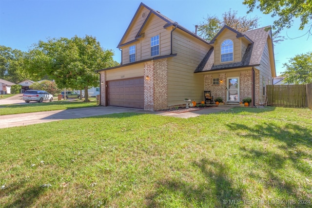 front of property featuring a front yard and a garage