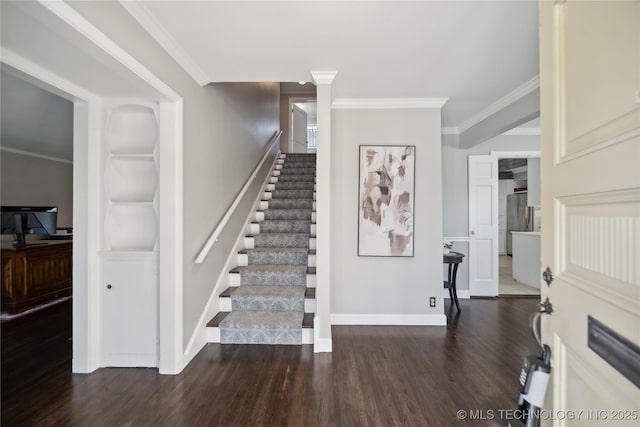 stairway featuring hardwood / wood-style floors, built in shelves, and ornamental molding