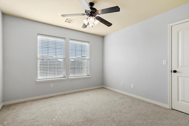 carpeted spare room featuring ceiling fan