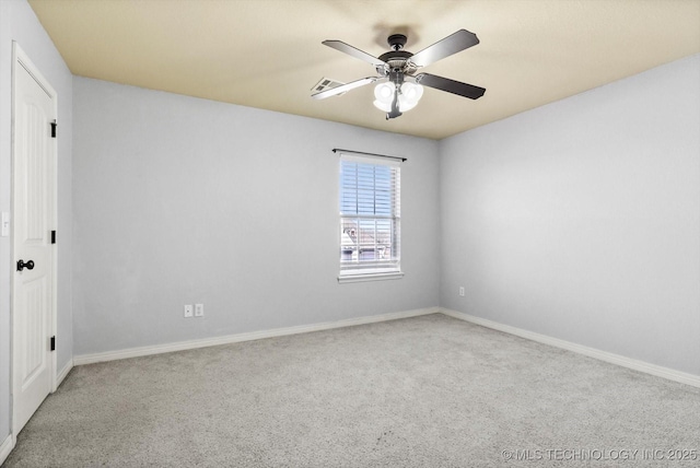 spare room with ceiling fan and light colored carpet