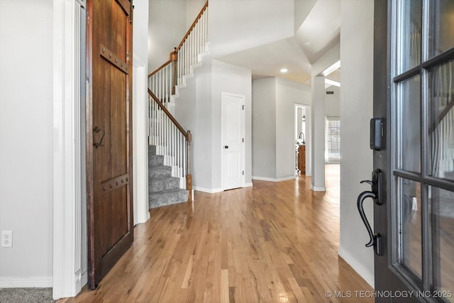 foyer featuring a barn door and light hardwood / wood-style flooring