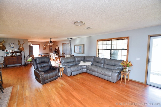 living room featuring hardwood / wood-style flooring and a textured ceiling