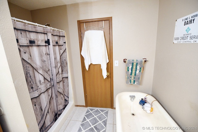 bathroom with independent shower and bath, a textured ceiling, and tile patterned flooring