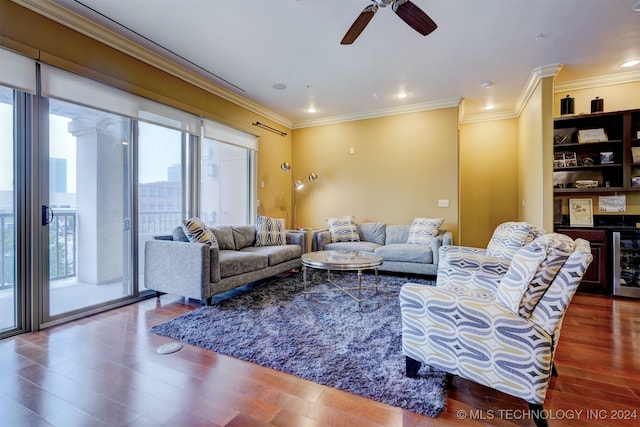 living room with ceiling fan, beverage cooler, crown molding, and dark wood-type flooring