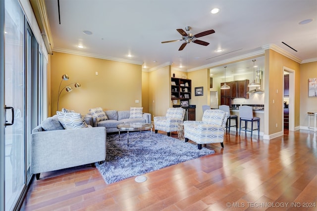 living room featuring crown molding, ceiling fan, and hardwood / wood-style flooring