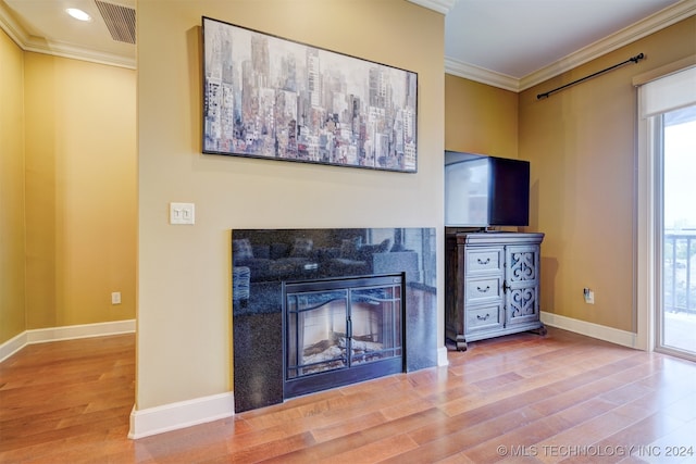 unfurnished living room with wood-type flooring and ornamental molding