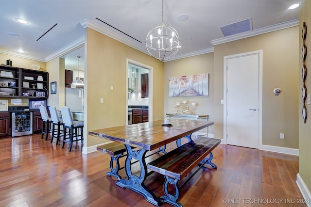 dining room featuring wood-type flooring, beverage cooler, and ornamental molding