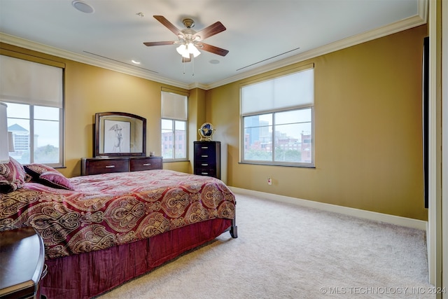 carpeted bedroom with ornamental molding and ceiling fan