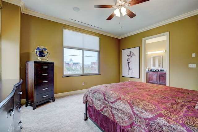 bedroom with ceiling fan, light colored carpet, connected bathroom, and crown molding