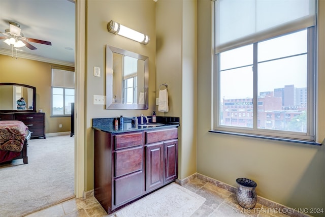 bathroom featuring ceiling fan, vanity, and crown molding