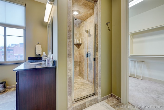 bathroom with vanity and a shower with door