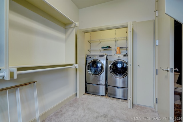 washroom with light carpet and washer and dryer