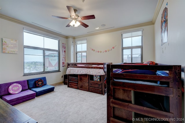 bedroom featuring ceiling fan, ornamental molding, and multiple windows