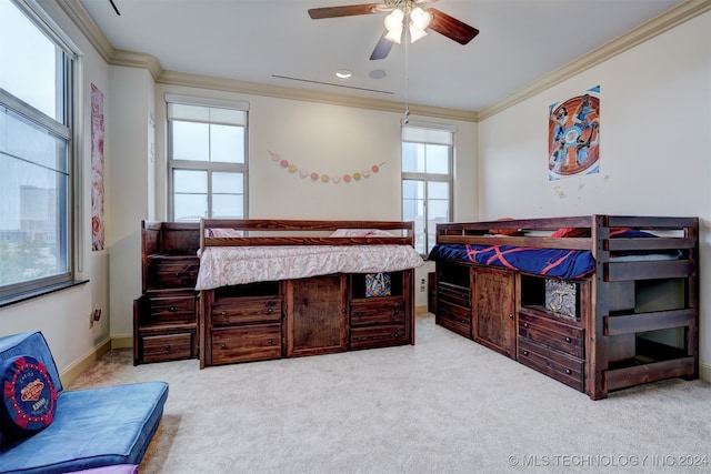 carpeted bedroom with ceiling fan and crown molding