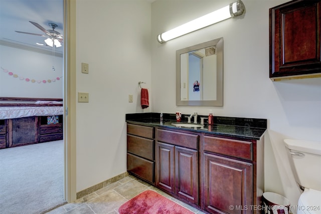 bathroom featuring ceiling fan, vanity, and toilet