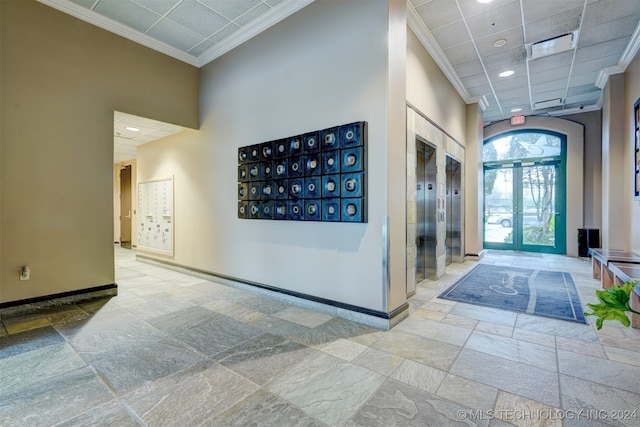 foyer entrance featuring crown molding, a towering ceiling, elevator, and french doors