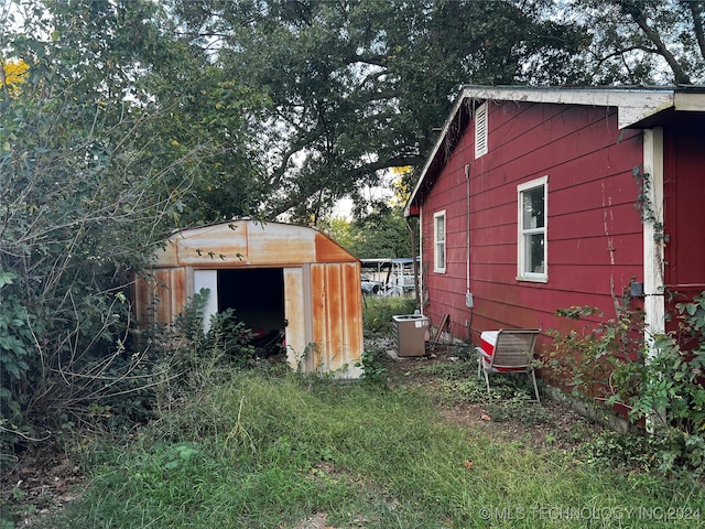 view of property exterior with a storage shed and central air condition unit