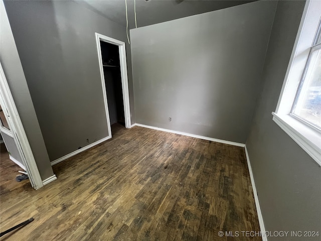 empty room featuring dark hardwood / wood-style flooring