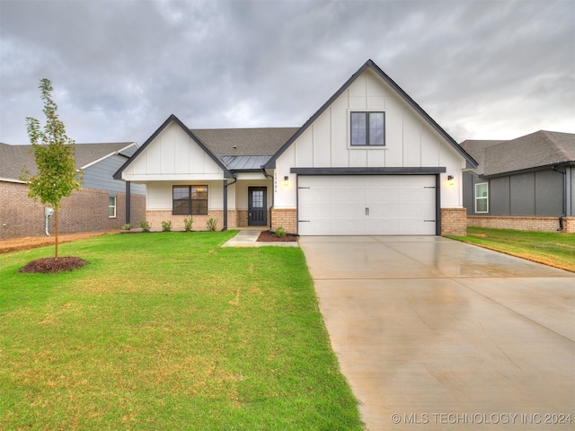 modern inspired farmhouse with a garage and a front lawn