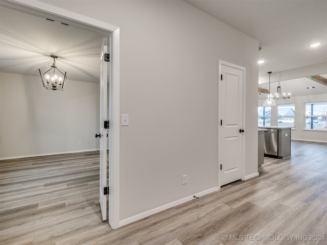 interior space featuring a chandelier and light hardwood / wood-style floors