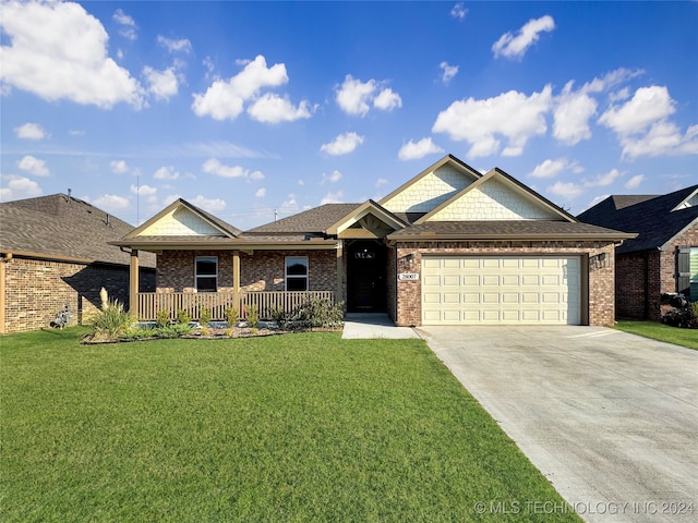 view of front of home featuring a garage and a front lawn